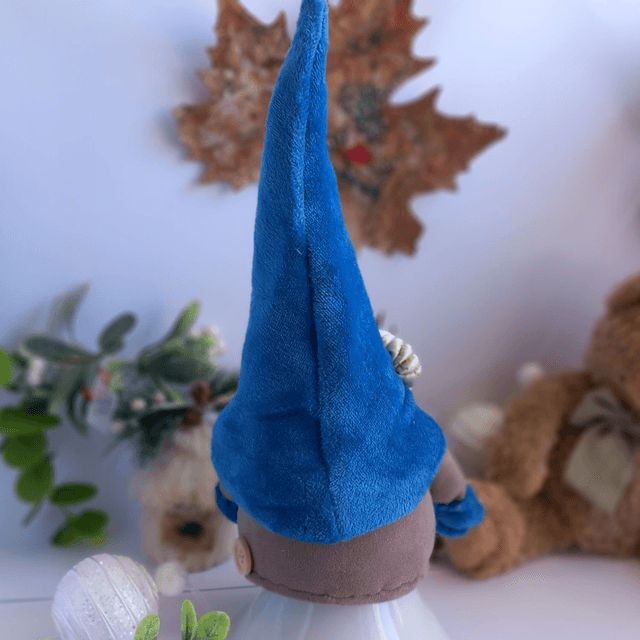 Tomte lutin de Noël au bonnet bleu et citrouilles 